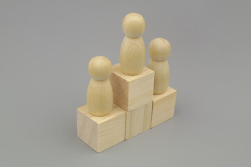 People figures on wooden steps  on gray background. Ranking people concept.