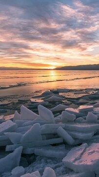 Timelapse moving over broken ice stacks on Utah Lake during sunset in winter from Utah Lake State Park.
