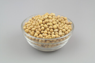 Soy beans in glass bowl on gray background