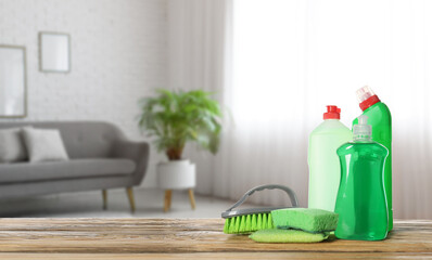 Set of cleaning supplies on table in room