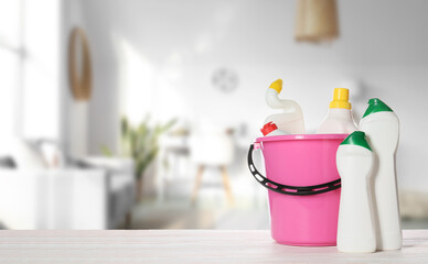Set of cleaning supplies on table in room