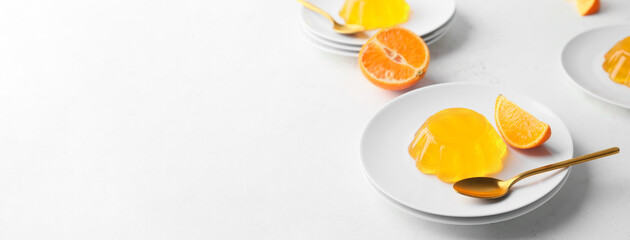 Plate with tasty orange jelly on white background with space for text