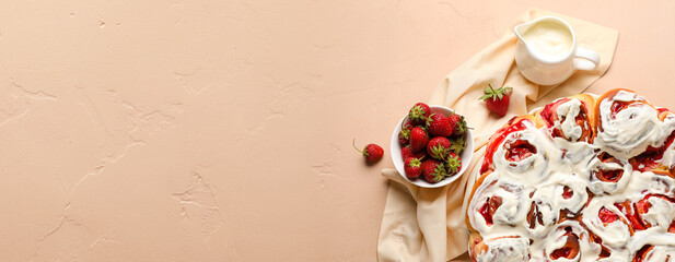 Baking dish with strawberry cinnamon rolls and cream on beige background with space for text