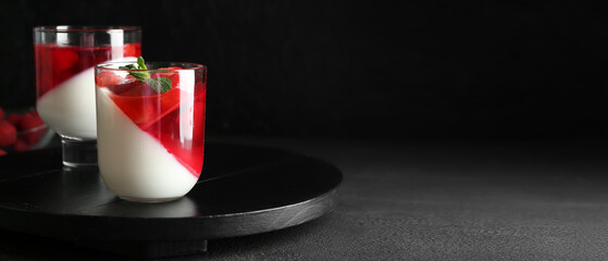 Glasses of tasty strawberry dessert on dark background with space for text