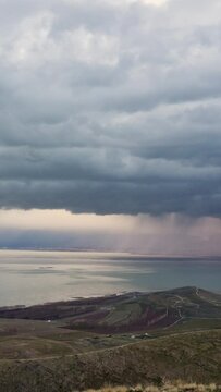 Looking over Utah lake as clouds build and bring heavy rainstorm as it moves through the valley.