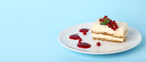 Plate with tasty tiramisu on blue background with space for text