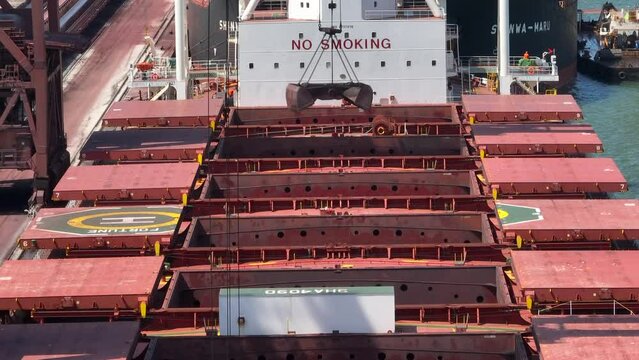 Cranes Unloading a Bulk Carrier Ship at Port