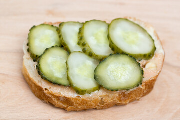 small open sandwich with spread and cucumber