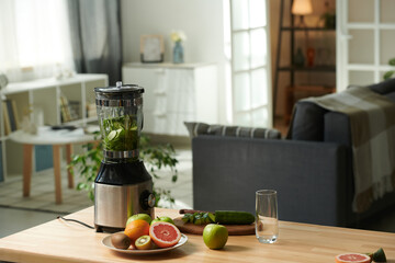 Horizontal image of kitchen table with fresh fruits and vegetables for preparing smoothie in blender