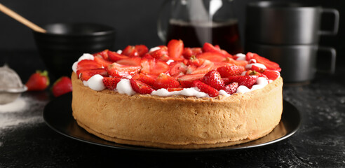 Plate with tasty strawberry cake on table