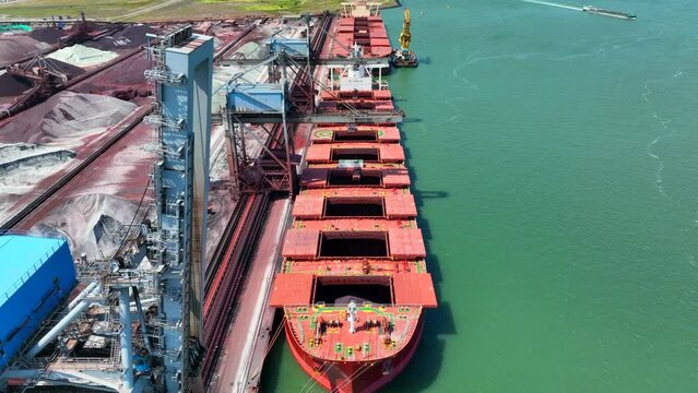 Bulk Carrier Ship Offloading Cargo By Crane for Processing