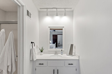 Modern Efficiency: Short-Term Rental with White Cabinets, Wood Floors, and Open Floor Plan