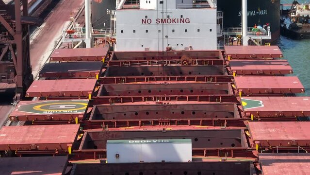Cranes Unloading a Bulk Carrier Ship at Port
