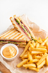 Club Sandwich with Cheese, PIckled Cucmber, Tomato and Smoked Meat. Garnished with French Fries