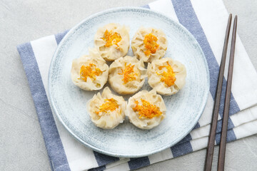 Steamed dumpling dimsum served in plate, close up.