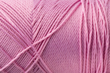 Macro texture of pink silk luxury thread, close-up, copy space. Macro Photography of a coil with...