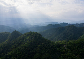 Obraz premium Top view Landscape of Morning Mist with Mountain Layer at north of Thailand. mountain ridge and clouds in rural jungle bush forest