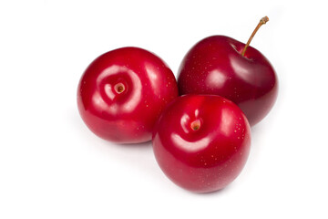 Three plums on a white background.