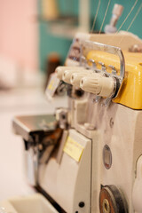 Detail of a sewing machine regulators on a table in a sewing workshop.