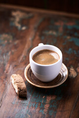 Cup of coffee and Cantuccini (Italian cookie) on dark wooden background. Close up. Copy space.                              