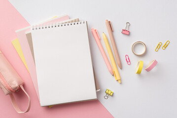 Back to school concept. Top view photo of girlish school supplies stack of notepads pens binder clips adhesive tape and pencil-case on bicolor pink and white background with blank space