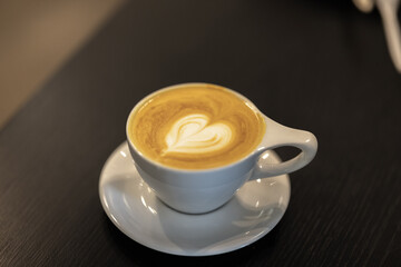 Cup of coffee with creative foam heart