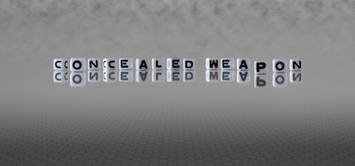 concealed weapon word or concept represented by black and white letter cubes on a grey horizon...