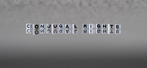 conjugal rights word or concept represented by black and white letter cubes on a grey horizon background stretching to infinity