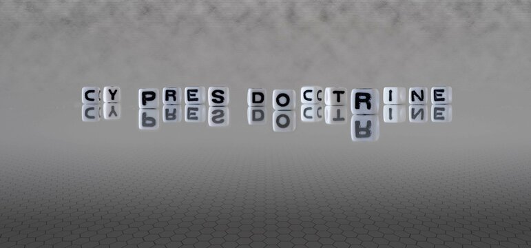cy pres doctrine word or concept represented by black and white letter cubes on a grey horizon background stretching to infinity