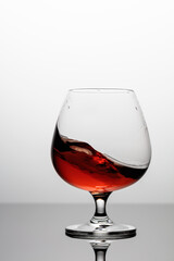 Splash of brandy in a snifter glass.