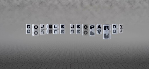 double jeopardy word or concept represented by black and white letter cubes on a grey horizon...
