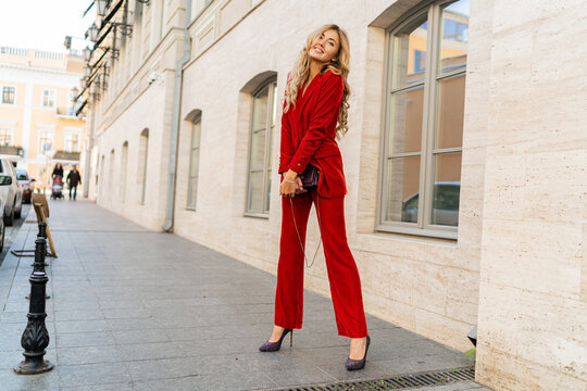 Fashion photo of beautiful blond woman   in stylish  luxury velvet suit posing outdoor.  Full lenght.
