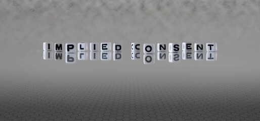 implied consent word or concept represented by black and white letter cubes on a grey horizon...