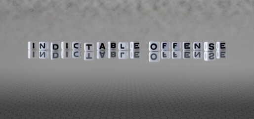 indictable offense word or concept represented by black and white letter cubes on a grey horizon...