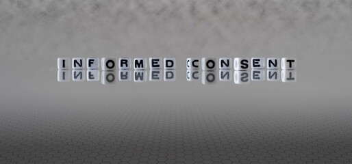 informed consent word or concept represented by black and white letter cubes on a grey horizon...