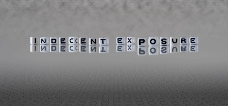 indecent exposure word or concept represented by black and white letter cubes on a grey horizon background stretching to infinity