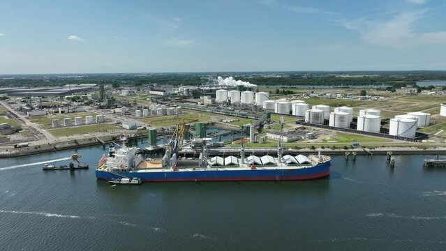 Bulk Carrier Ship at Port Offloading Cargo and Commodities