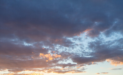 Naklejka na ściany i meble Clouds in the sky at sunset background.