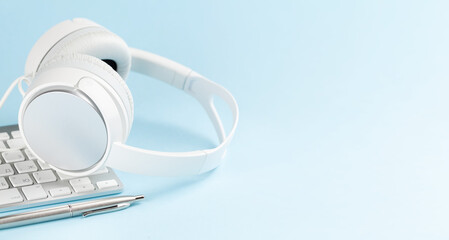 Headphones and laptop over blue background