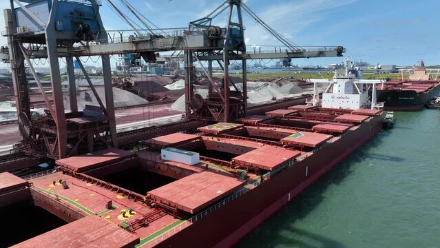 Bulk Carrier Ship Offloading Cargo By Crane for Processing