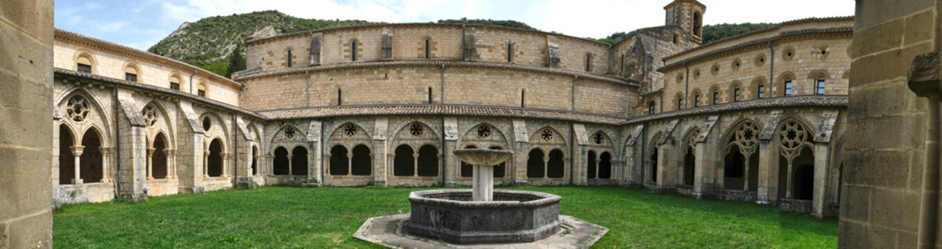 Monastery of Santa María la Real de Iranzu, interior courtyard with a central fountain surrounded by arches carved in stone, Navarra, Spain.