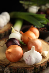 Fresh onion bulbs and garlic on table, closeup
