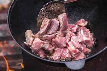 Recipe for potatoes with meat and vegetables in a cauldron in nature. Cooking. Cooking recipes....