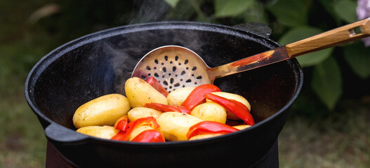 Recipe for potatoes with meat and vegetables in a cauldron in nature. Cooking. Cooking recipes....