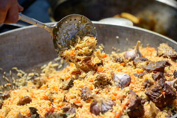 a large cauldron with Uzbek pilaf
