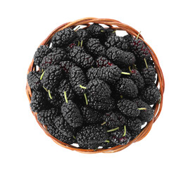 Ripe black mulberries in wicker bowl on white background, top view