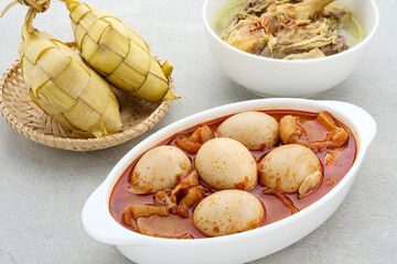 Sambal Goreng Telur Krecek, is javanese traditional food. Served in white bowl on wooden table....