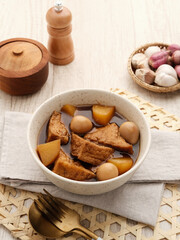 Semur, Indonesian traditional food, with tofu, quail eggs and potatoes, served in a bowl