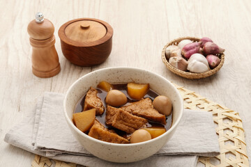 Semur, Indonesian traditional food, with tofu, quail eggs and potatoes, served in a bowl