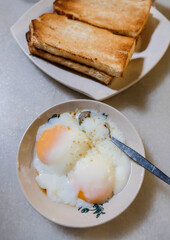 Breakfast in Malaysian Chinatown. Hainanese Breakfast. Toasted bread with butter and kaya, half boiled eggs and strong rich coffee, a must try meal.